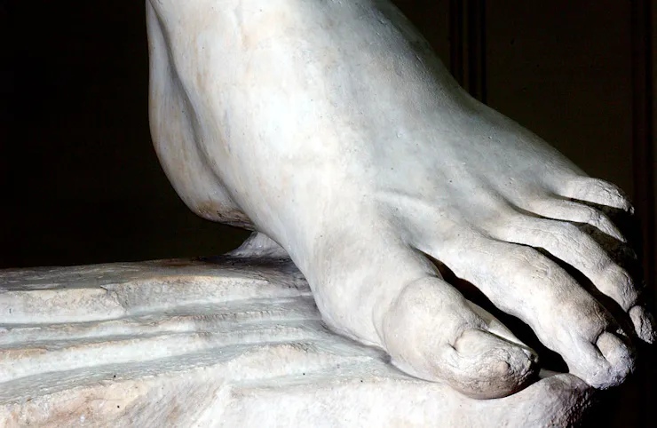 A white, marble-carved foot.