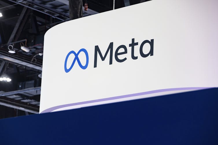 A large white sign with the name 'Meta' on it.