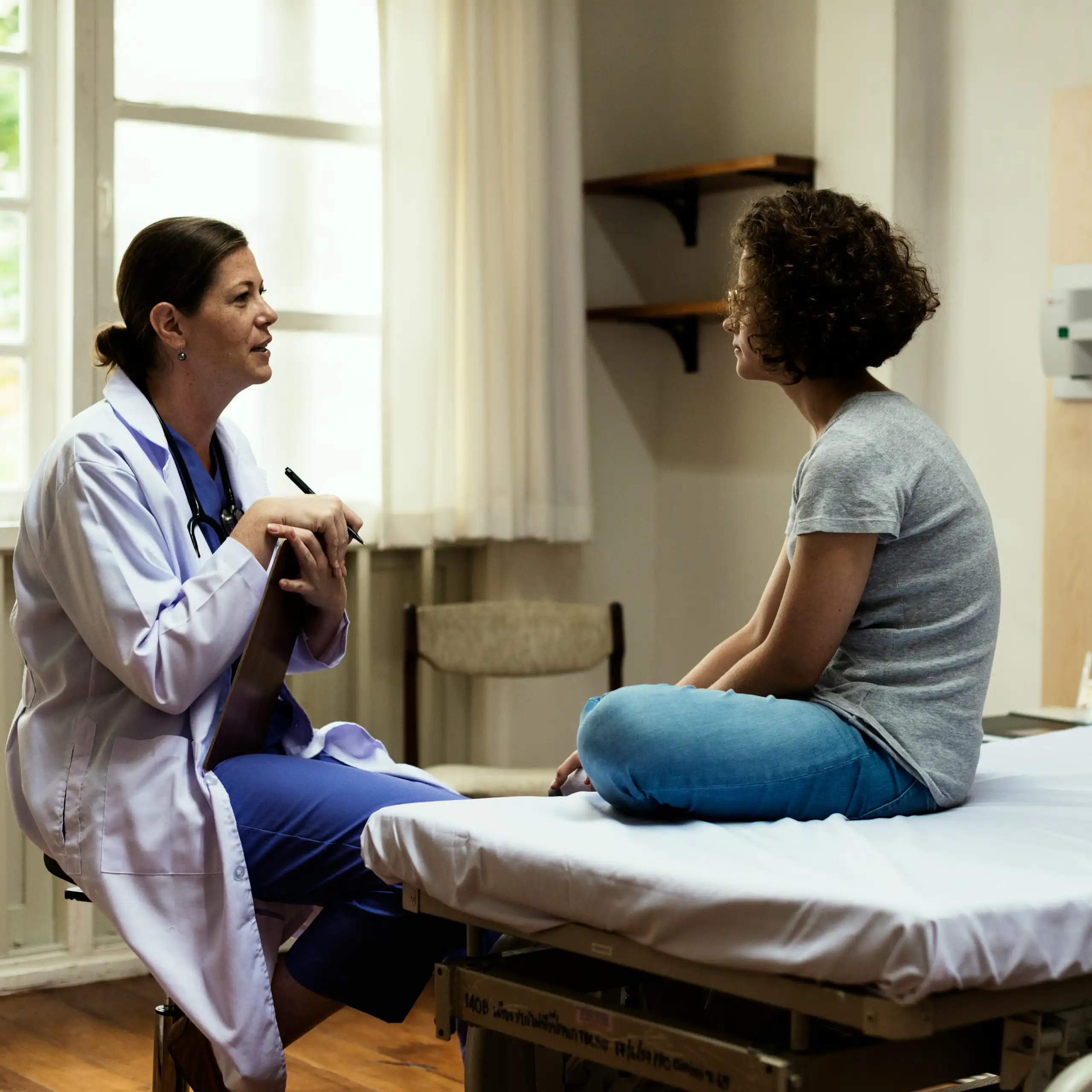 A doctor consulting with a young woman.