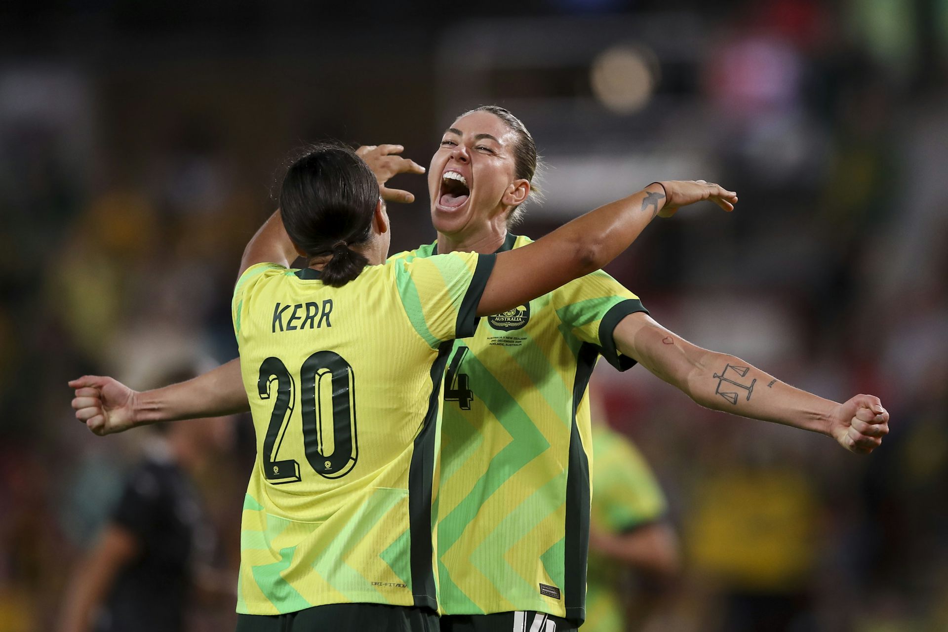 Alanna Kennedy of the Matildas celebrates a goal with teammate Sam Kerr.