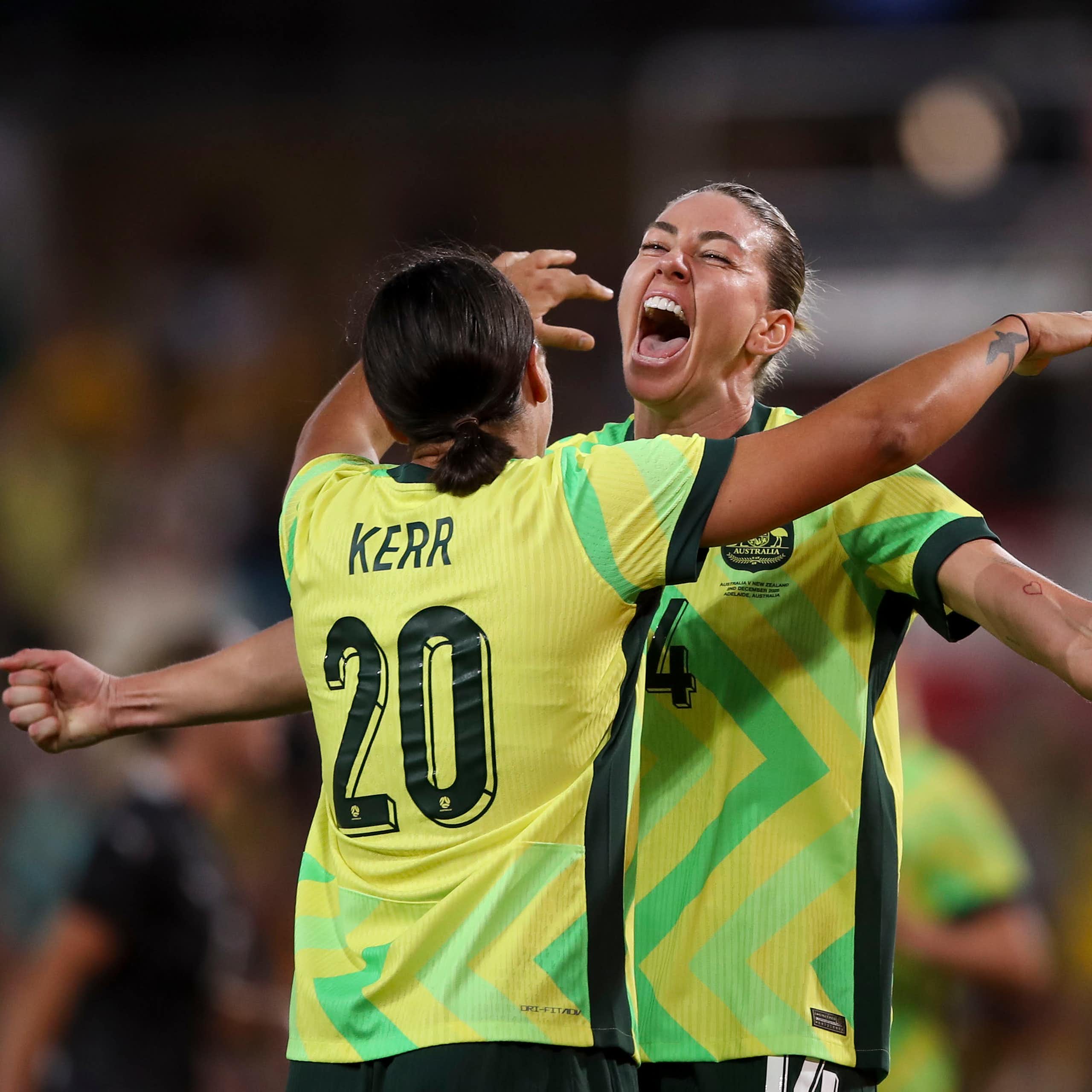 Alanna Kennedy of the Matildas celebrates a goal with teammate Sam Kerr.