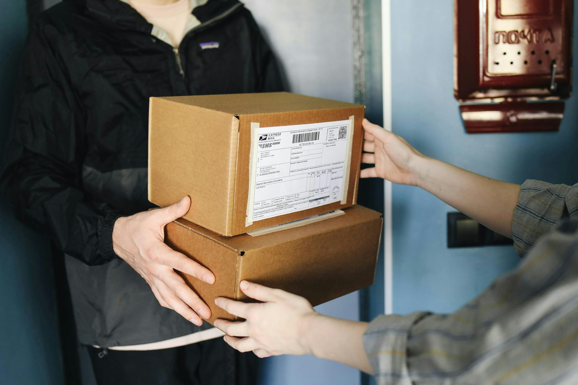 A person receiving two parcels via delivery