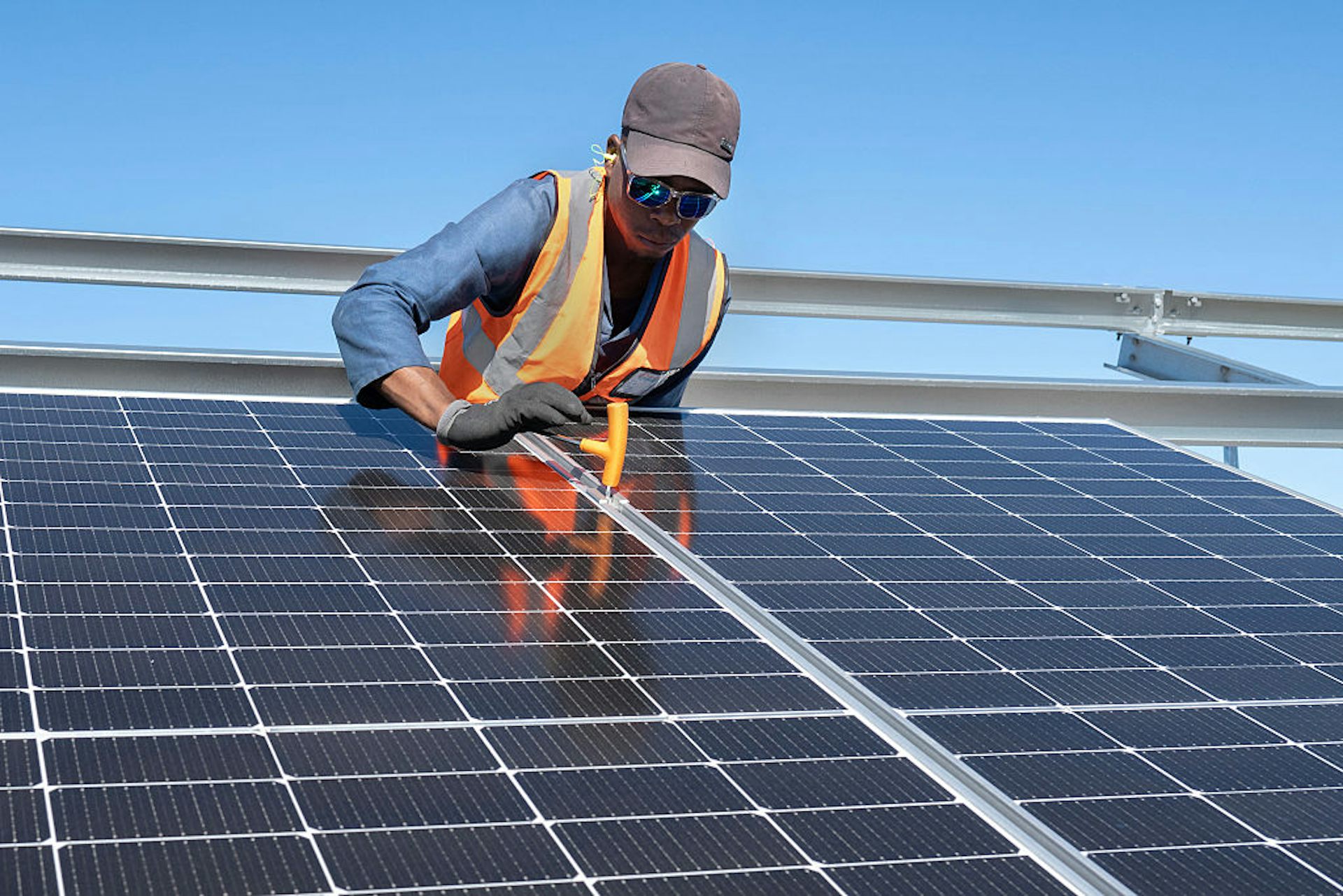 Worker fitting solar panels on a frame