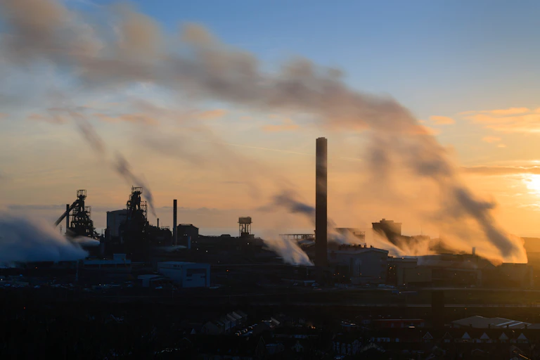 skyline of industrial factory chimneys, smoke, evening sunset sky