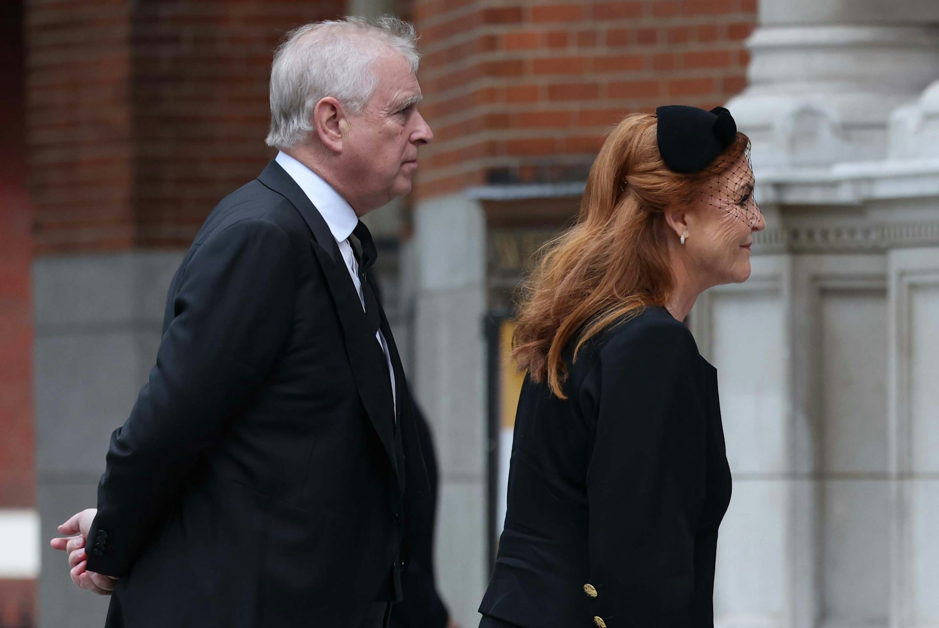 Side view of Mountbatten-Windsor and Ferguson walking into the Duchess of Kent's funeral