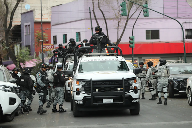 Members of the Mexican national guard stand guard on a street in Mexico City.