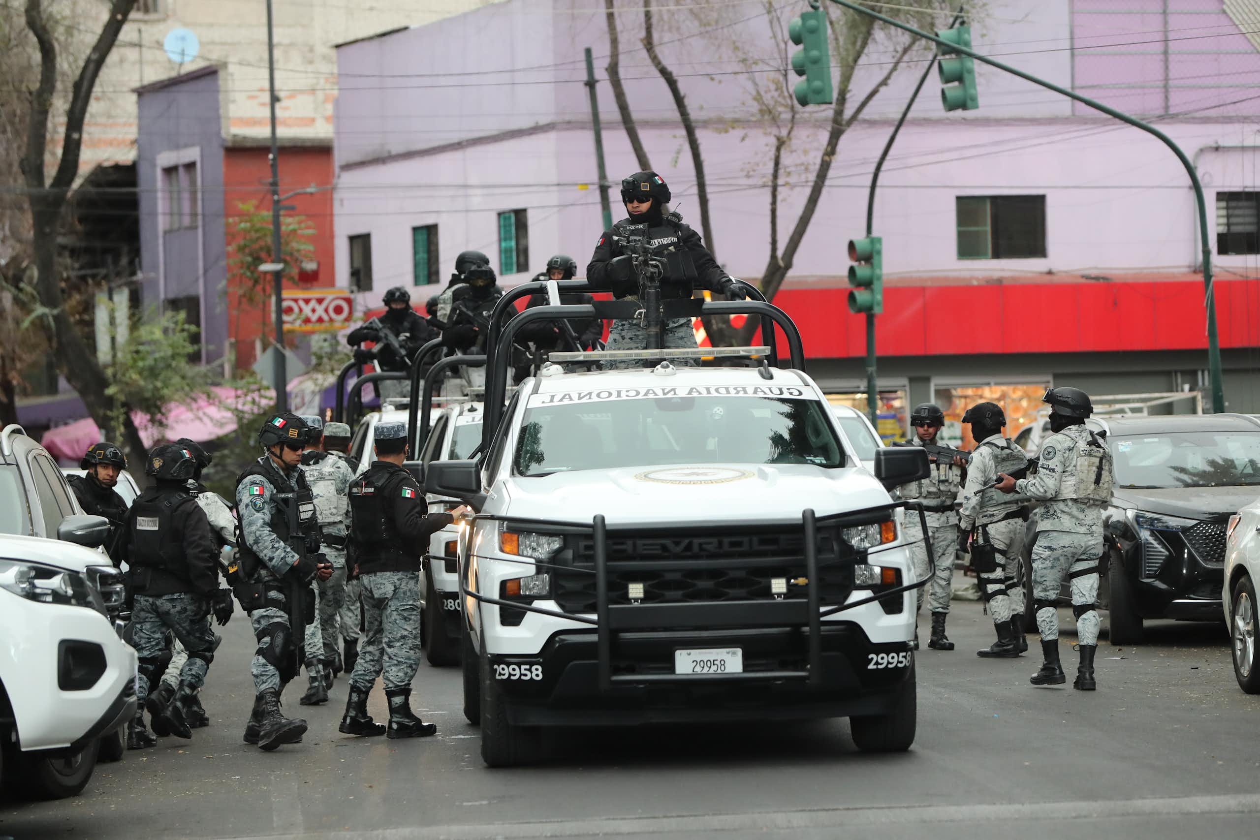 Members of the Mexican national guard stand guard on a street in Mexico City.
