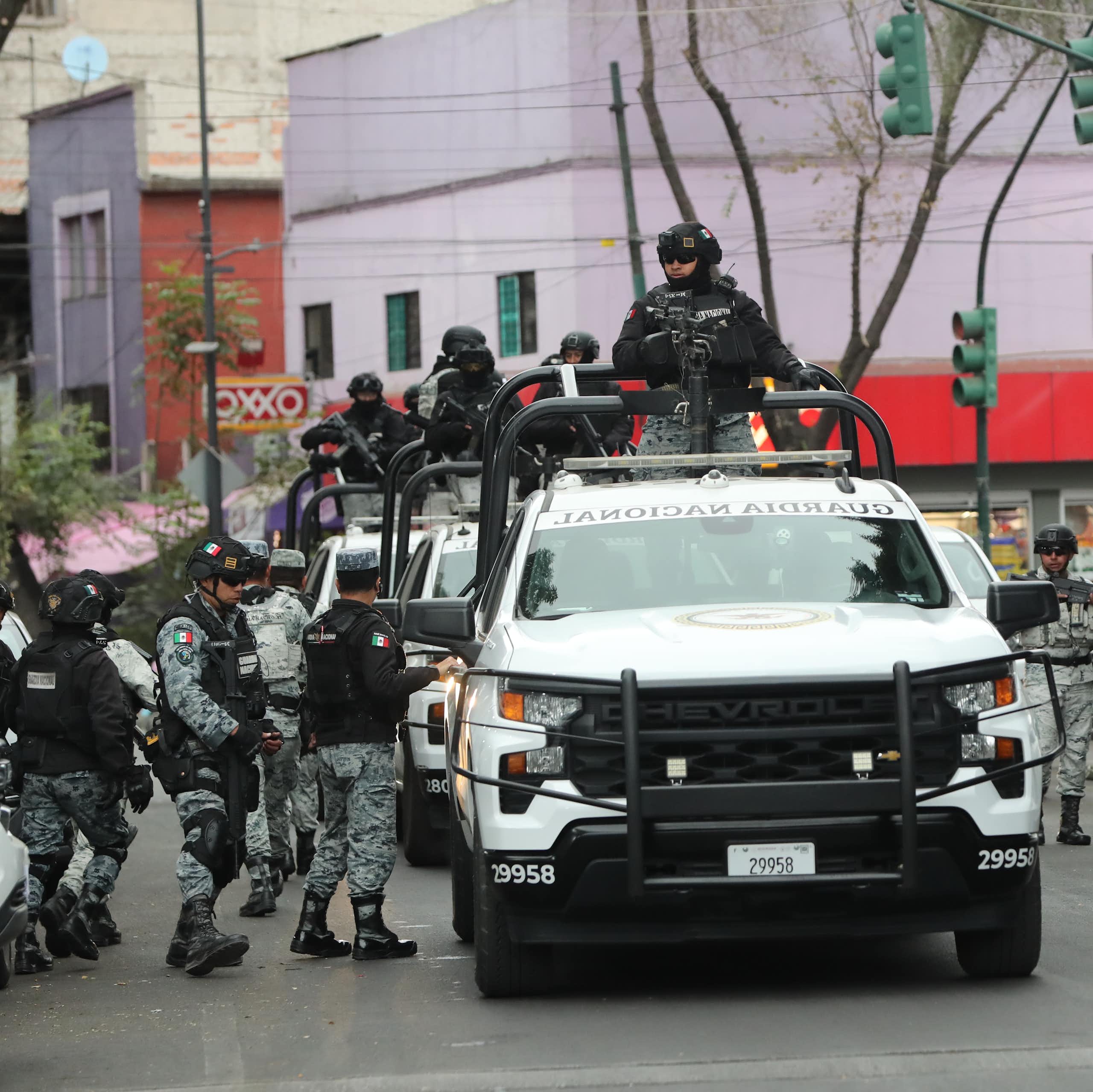 Members of the Mexican national guard stand guard on a street in Mexico City.
