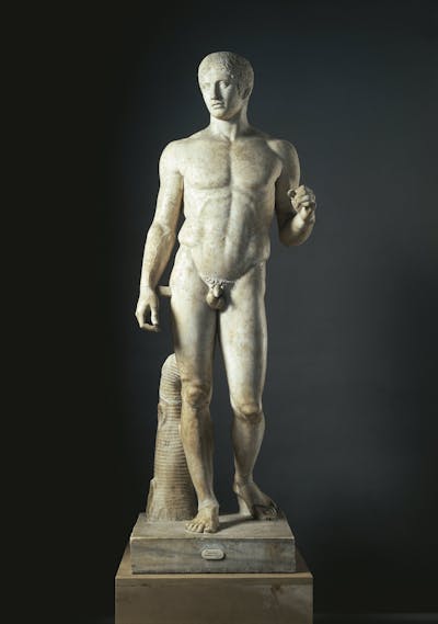 white stone statue of a naked man with one foot ahead of the other