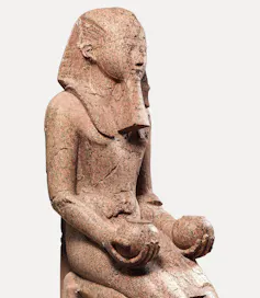 stone statue of a stylized person kneeling