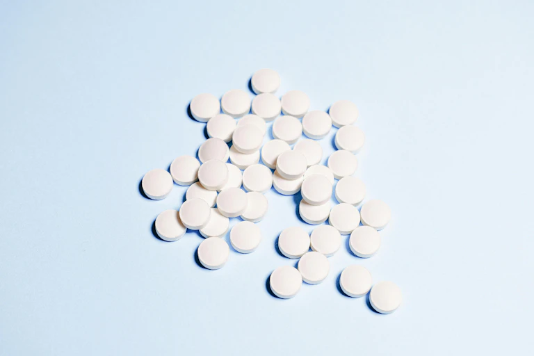 White round tablets on a blue background
