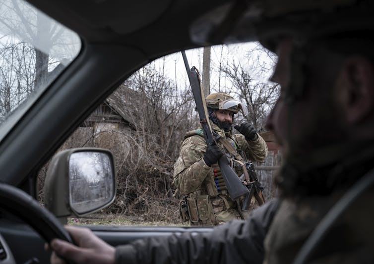 A Ukrainian servicemen stands guard in the Donetsk region.