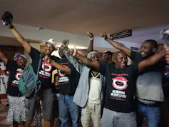 Activists wearing tshirts that say 'No mining on our land' celebrating