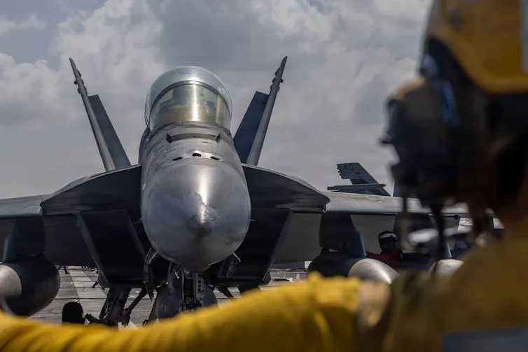 An F/A-18F Super Hornet lands on a US aircraft carrier, January 2026.