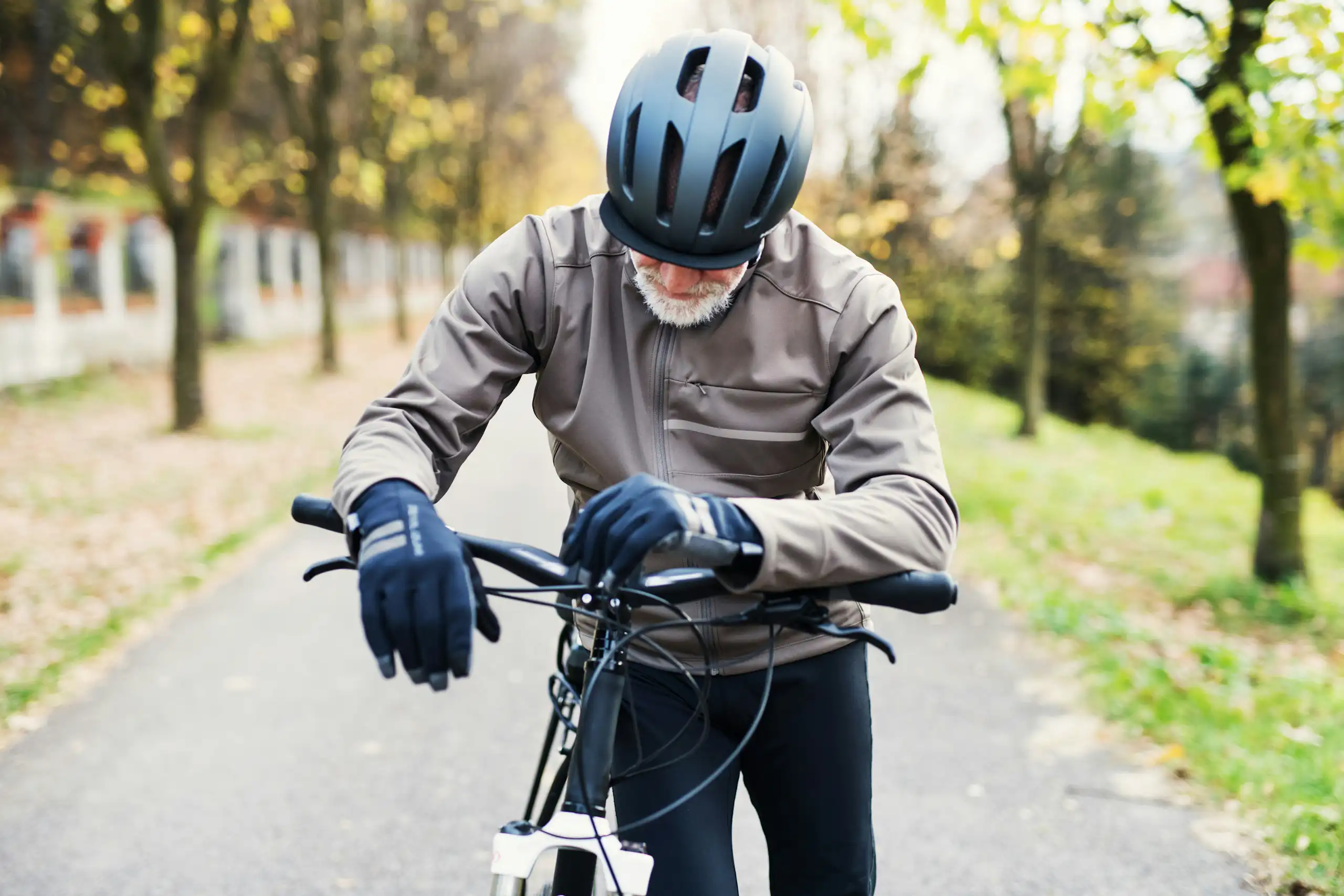 an elderly man on a bicycle