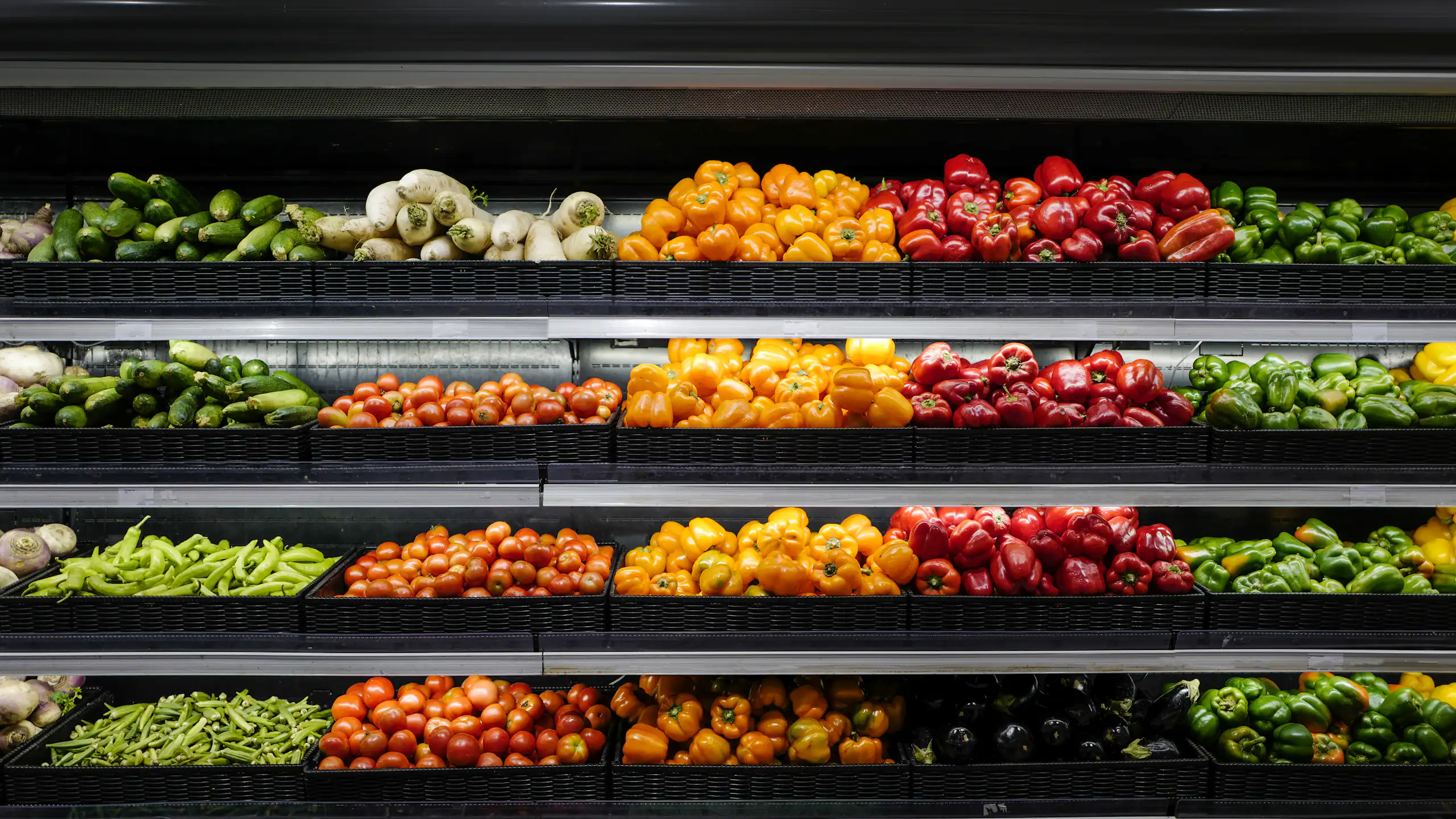 A closeup of a fruit and vegetable aisle in a supermarket