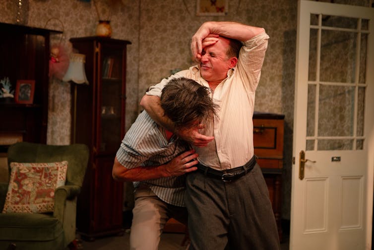 Production image: two men fight.