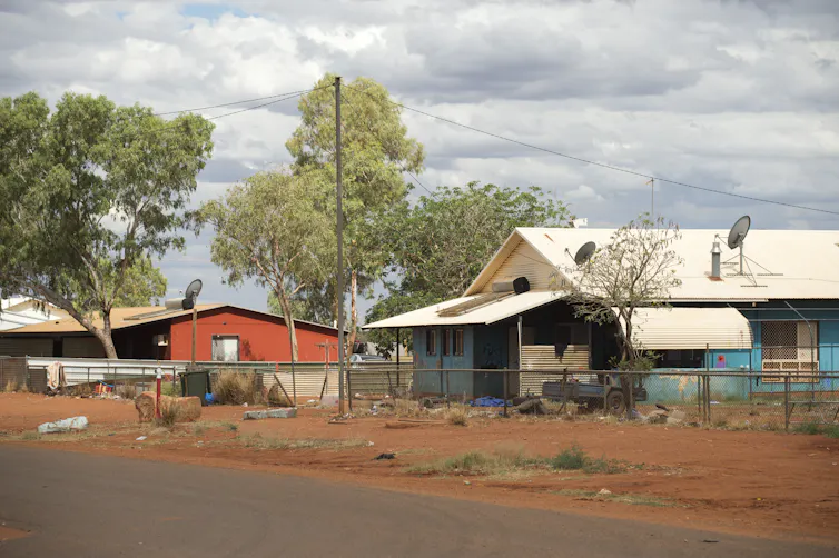 A street in a small Australian outback town with basic houses.