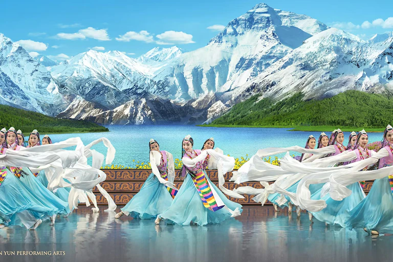 Dancers on stage in traditional Chinese dress.