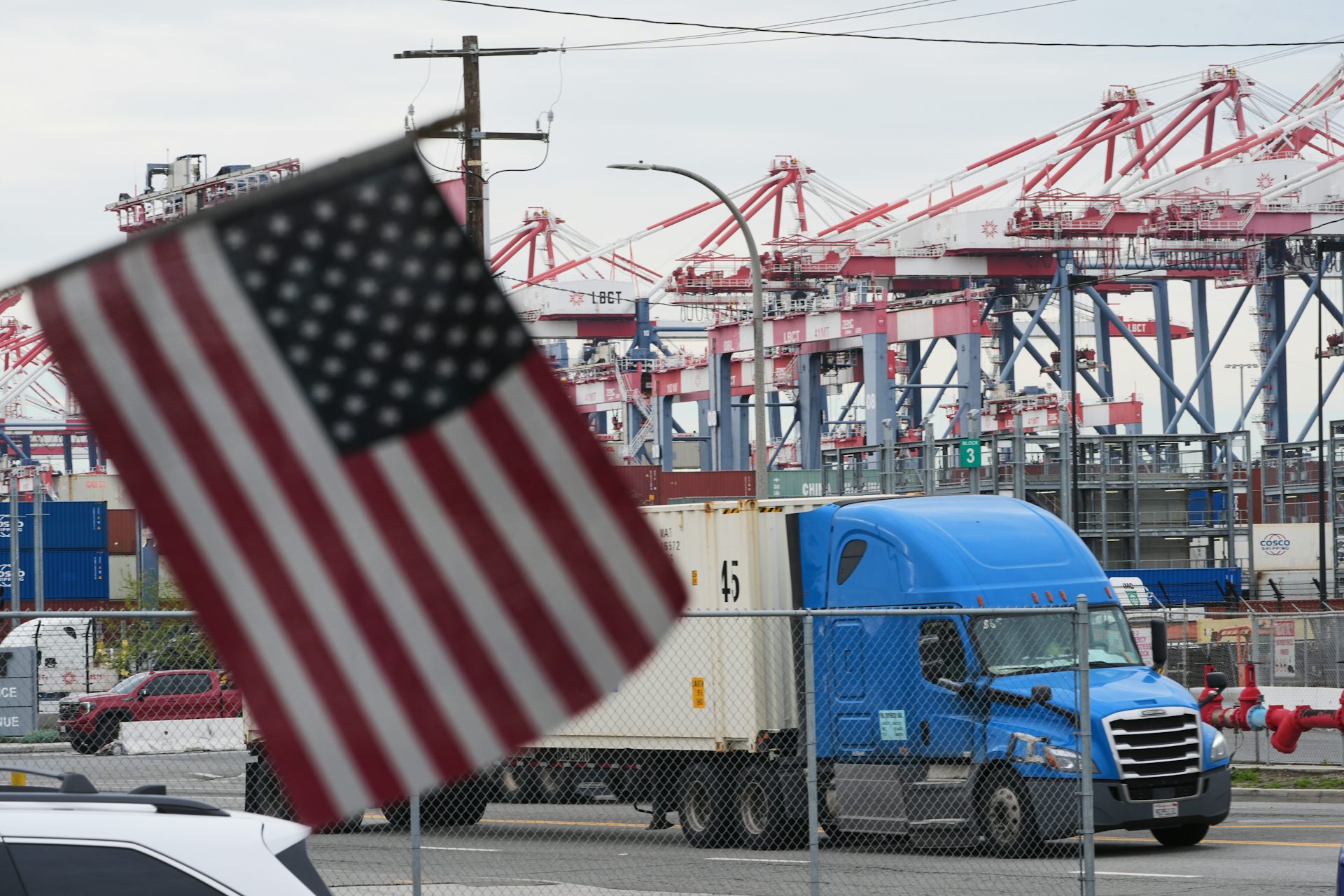 A U.S. flag flies in front of a port