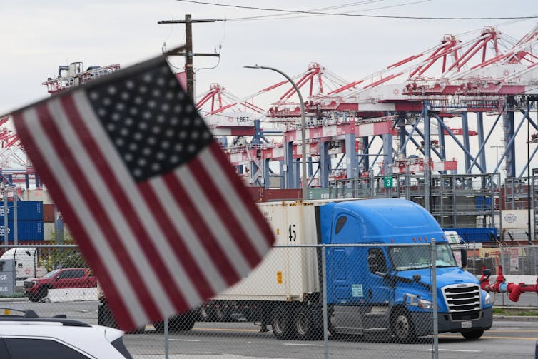 A U.S. flag flies in front of a port