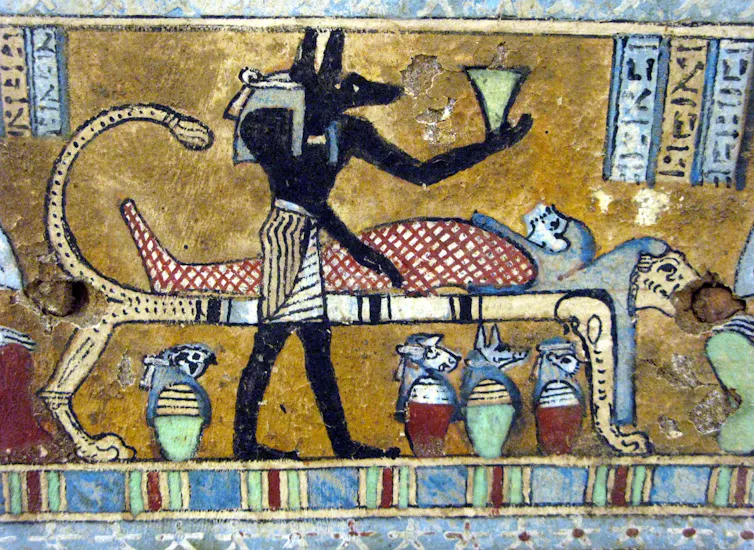 ancient Egyptian image of a human figure with a dog head