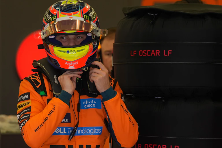 Oscar Piastri fiddles with his helmet during a Formula One pre-season test a Bahrain
