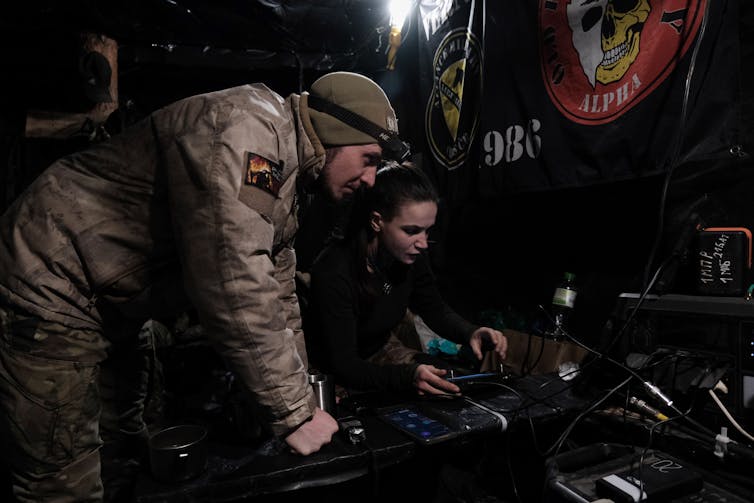 Two Ukrainian drone operators, a man and a woman, controlling a 'Vampire drone'.