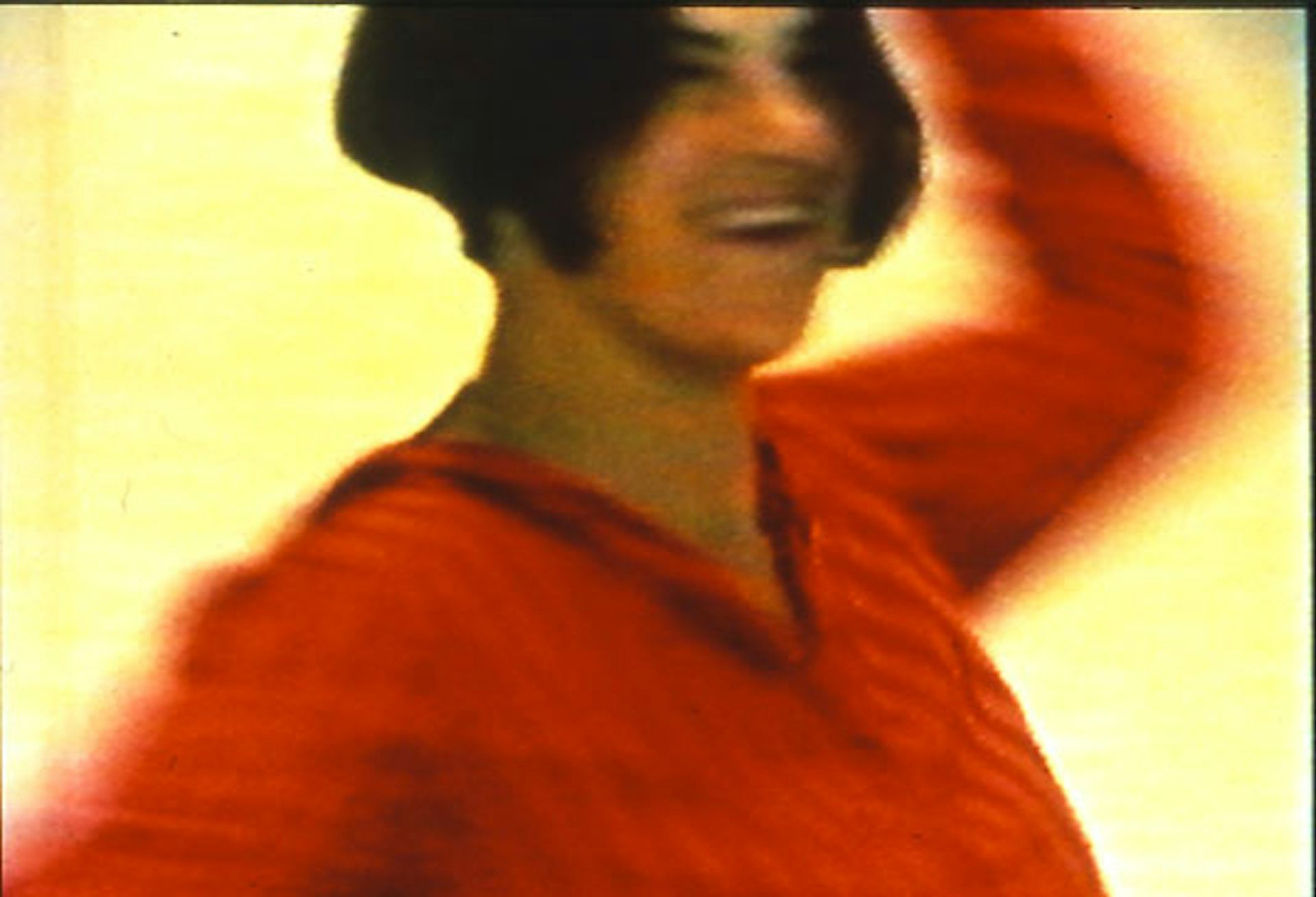 Tracey Emin in a red shirt with cropped hair.