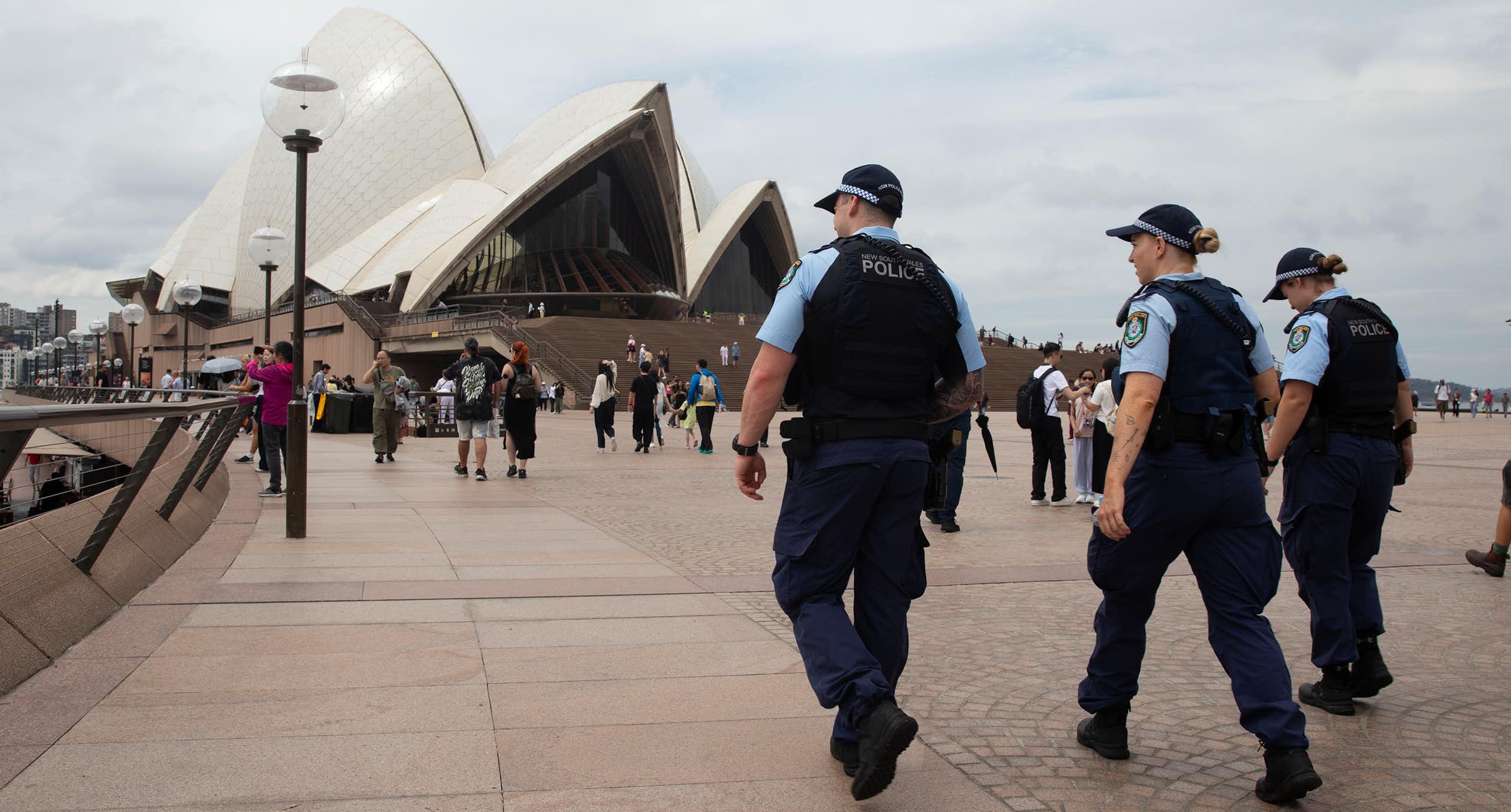 Police walk by the Sydney Harbour foreshore.