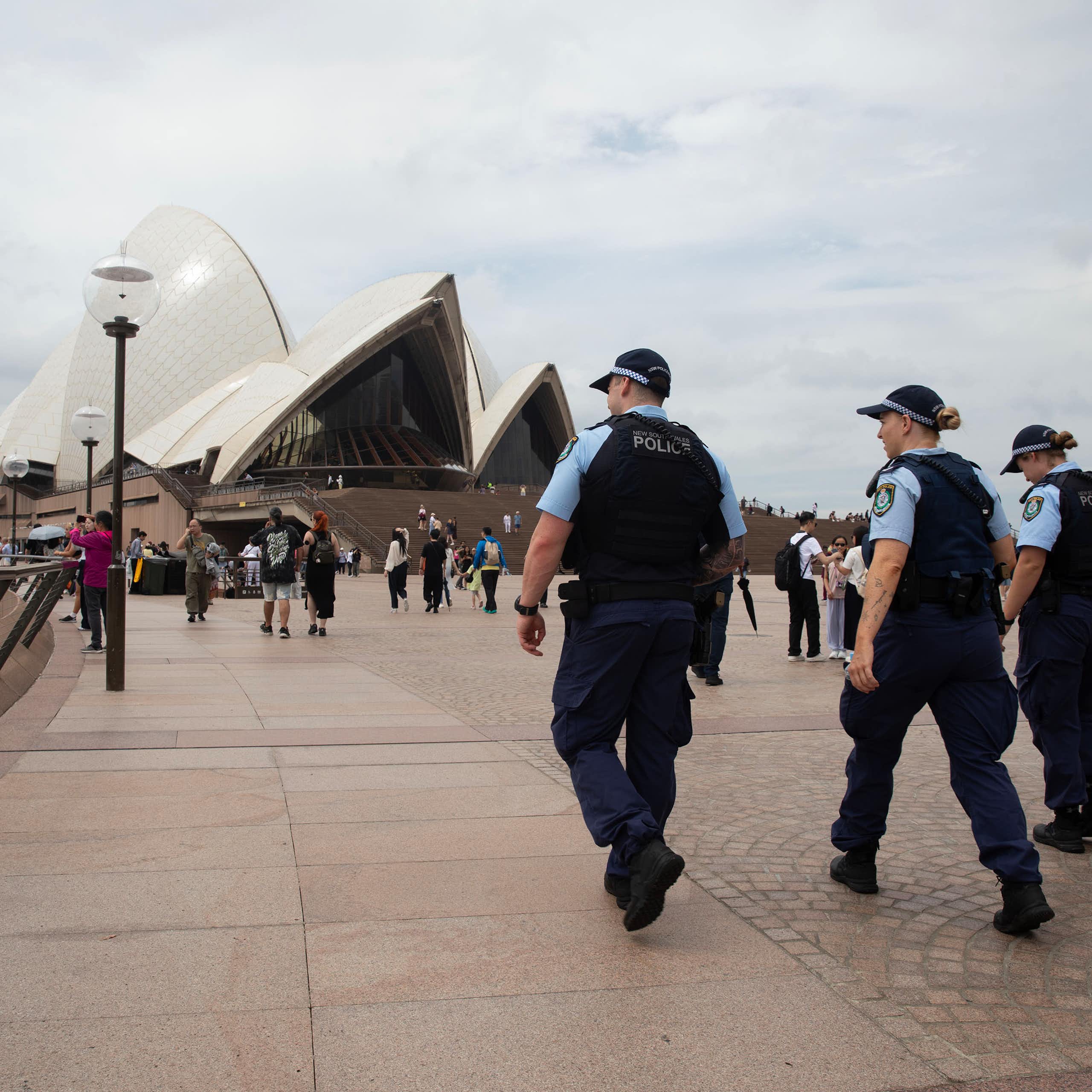 Police walk by the Sydney Harbour foreshore.