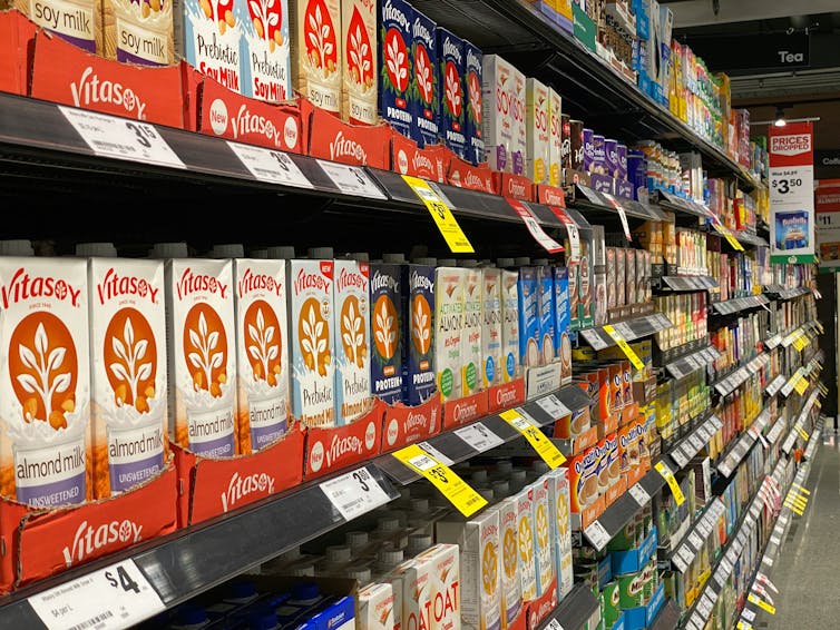 Rows of plant-based soy, almond and oat milk at an Australian supermarket