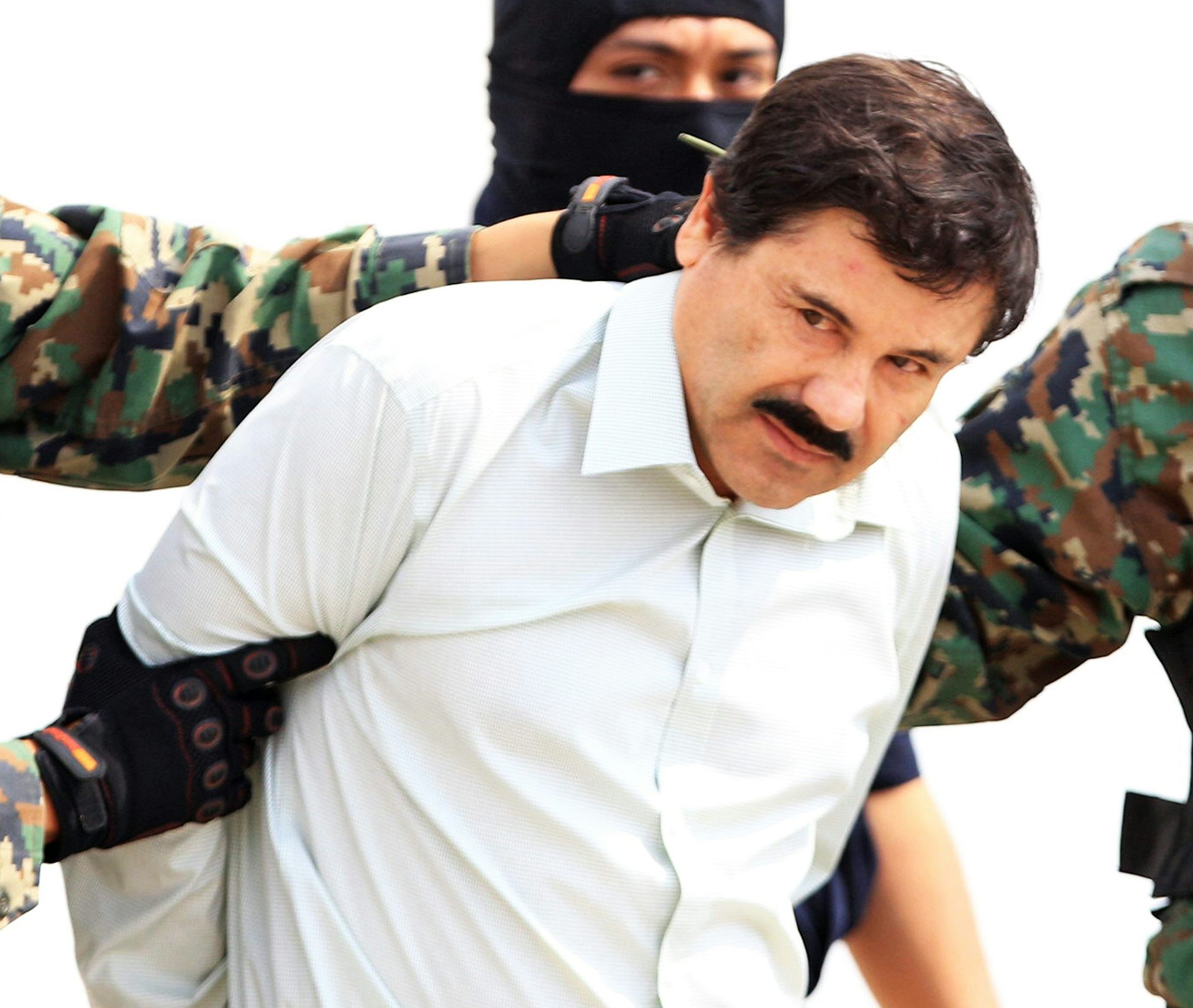 Joaquin 'El Chapo' Guzman being led away by Mexican security agents.
