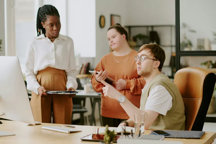 Three differently abled people working together in an office.