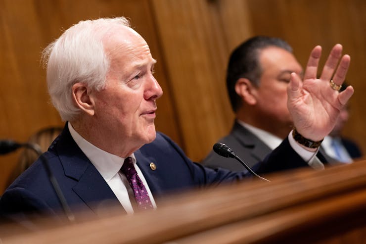Texas Sen. John Cornyn gestures with his left hand while speaking at a committee hearing.