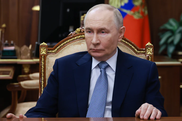 Russian President Vladimir Putin attends a meeting. He looks a bit sad.