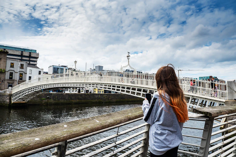 Girl on phone by Penny bridge, Dublin