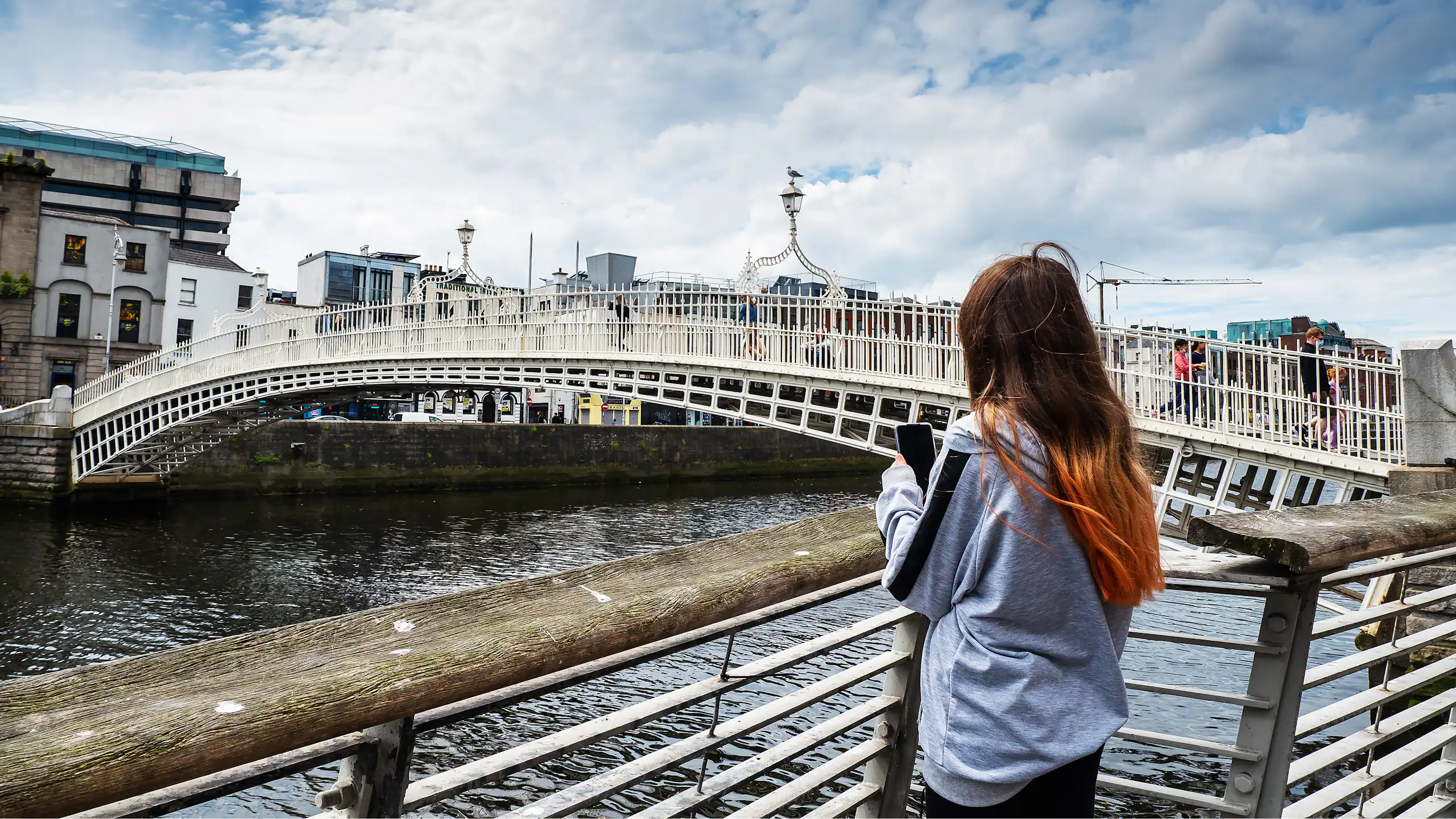Girl on phone by Penny bridge, Dublin