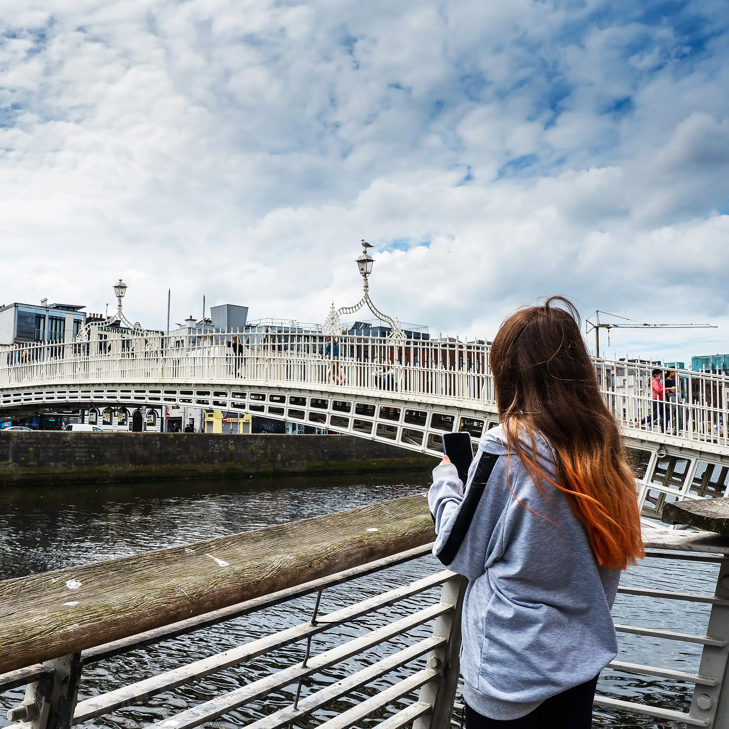 Girl on phone by Penny bridge, Dublin