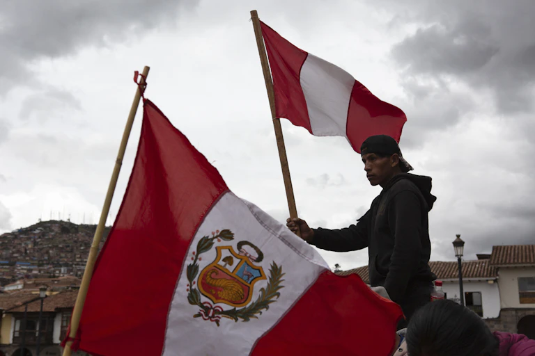 A man waves a red and white flag