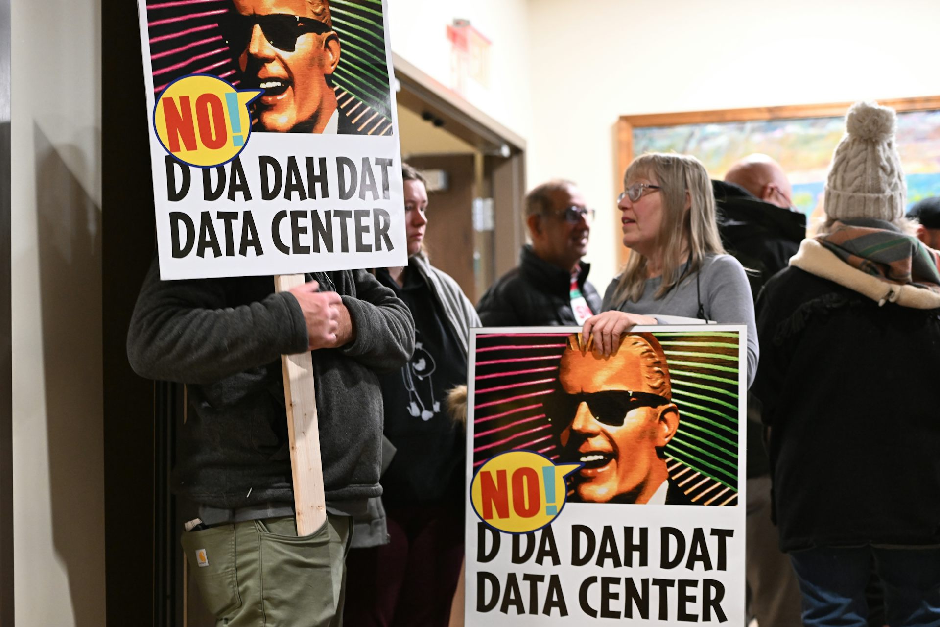 People hold signs that say 'No! D Da Dah Dat Data Center'