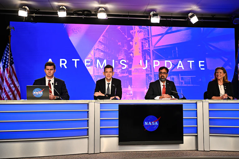 A panel of four people sitting in front of a screen reading 'Artemis Update'