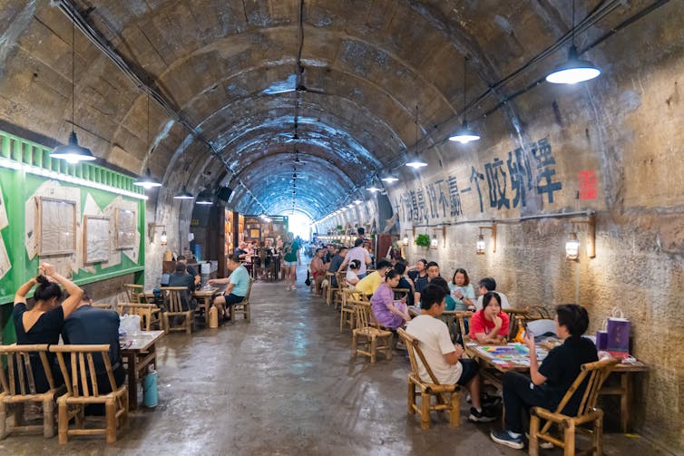 Residents drink tea in a former bomb shelter as high temperatures continue in Chongqing, China.