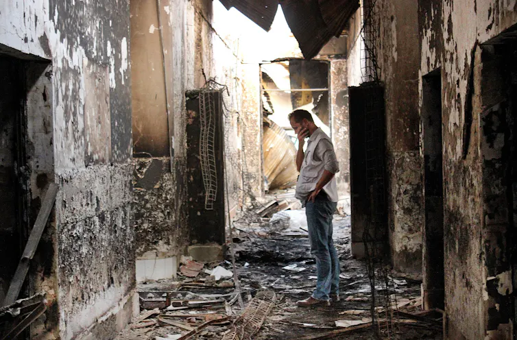 A Doctors Without Borders employee walks inside the charred remains of the organisation's hospital after it was hit by a US airstrike in Afghanistan in 2015.