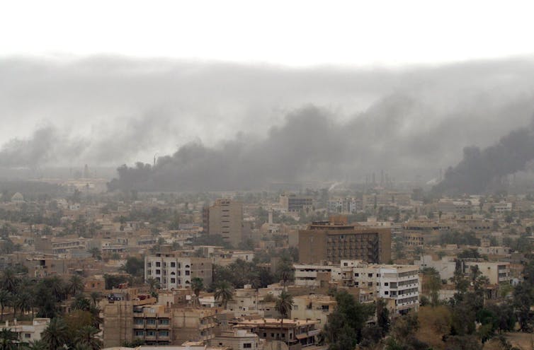 Heavy smoke rises above Baghdad 08 April 2003 after coalition warplanes struck Iraqi President Saddam Hussein's Republican Palace
