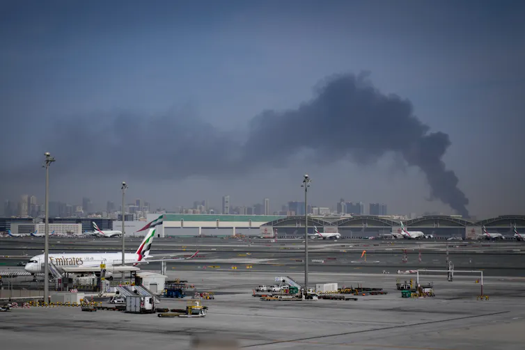 Smoke seen rising near Dubai International Airport following an Iranian strike.