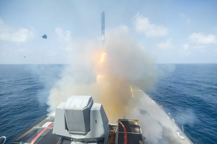 A US warship fires a missile at a target in Iran.