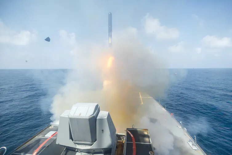 A US warship fires a missile at a target in Iran.