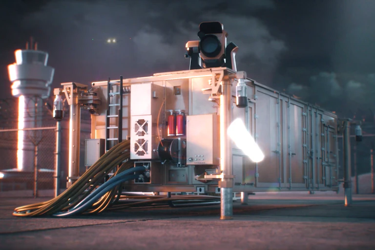 Photo of a large optical device mounted on a shipping container like structure.