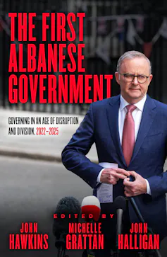 book cover: The First Albanese Government, a man buttoning his suit jacket